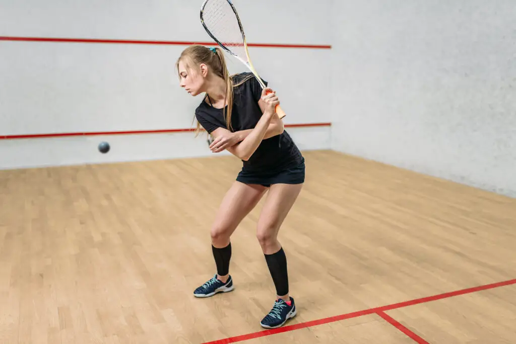 female squash player lining up a downswing to play a shot